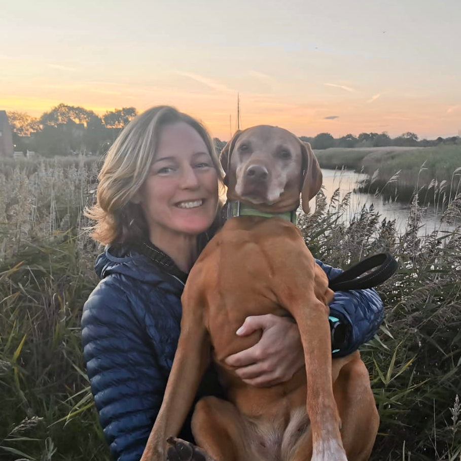 Female founders Emma and her Dog, Zulu with Snape Maltings and the river Alde in the background. 