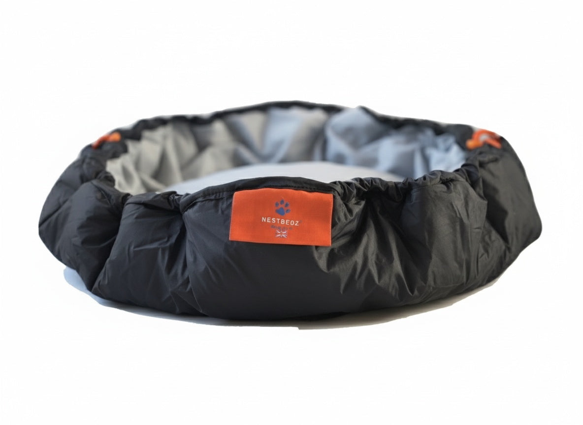 Black pet bed with orange label on a white background