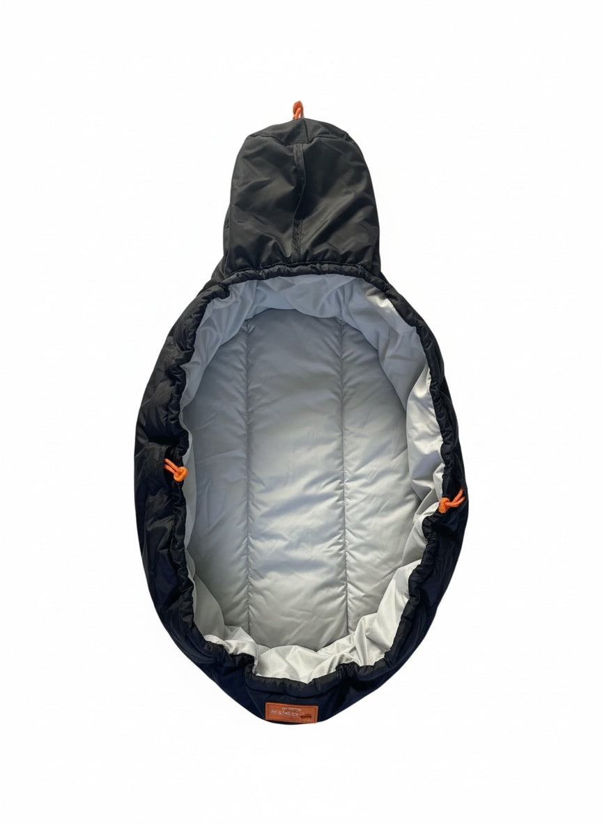 Cosy black and gray dog bed with orange accents on a white background